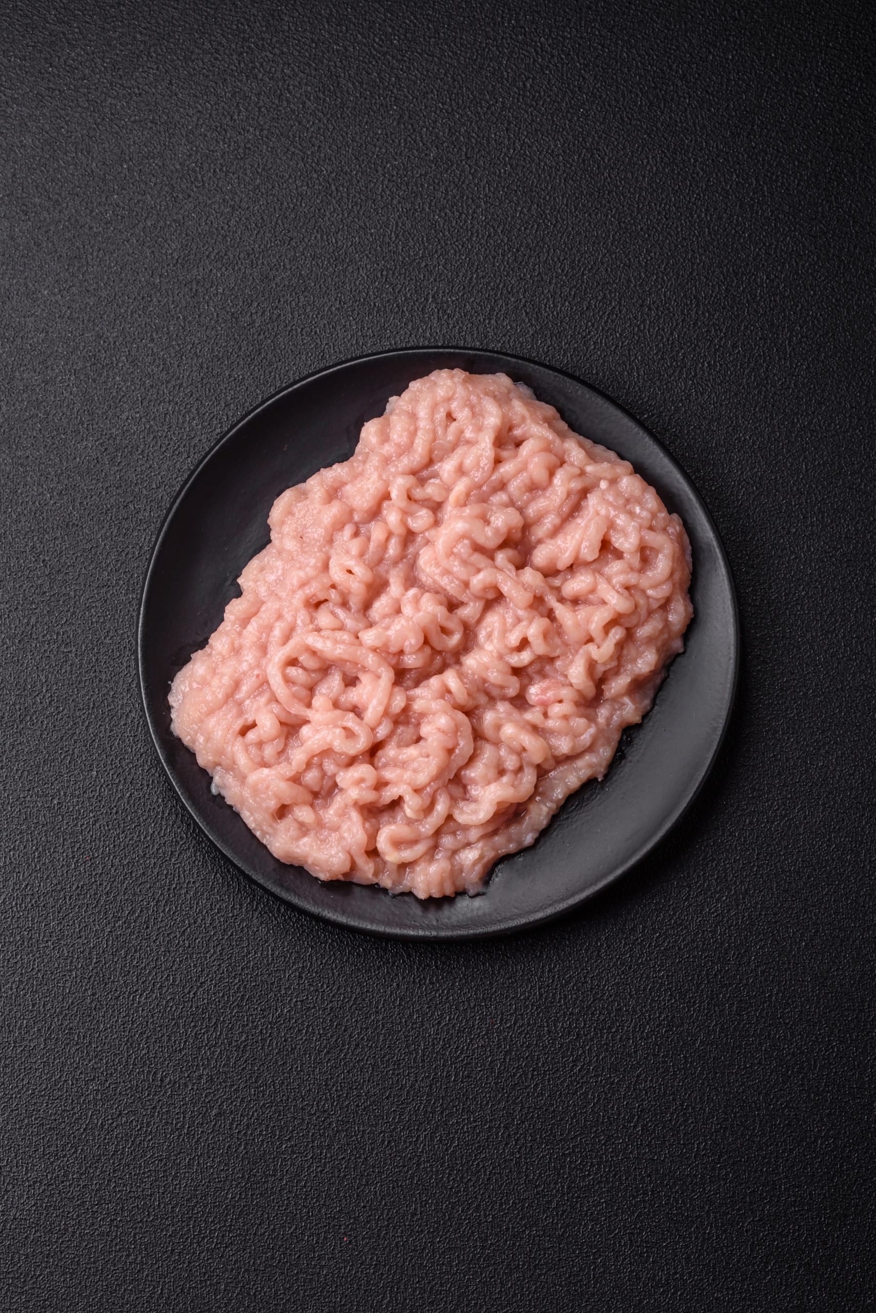 Fresh raw chicken mince with salt and spices